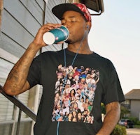 a man drinking a cup of coffee while wearing a black t - shirt